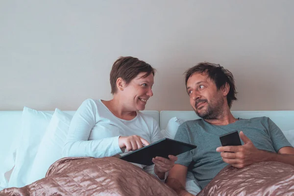 Happy couple, husband and wife in bedroom