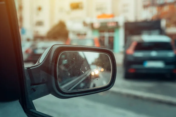 Weerspiegeling van het stadsverkeer in auto side mirror — Stockfoto