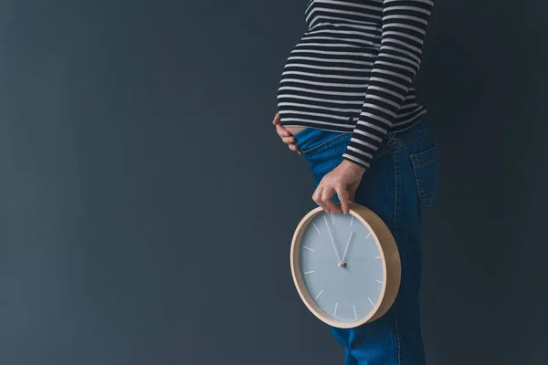 Pregnant female with vintage alarm clock — Stock Photo, Image