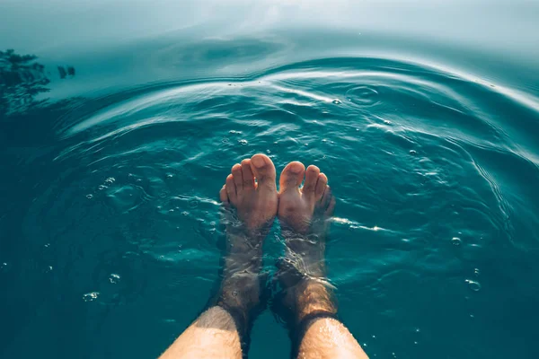 Male feet in outdoor swimming pool — Stock Photo, Image