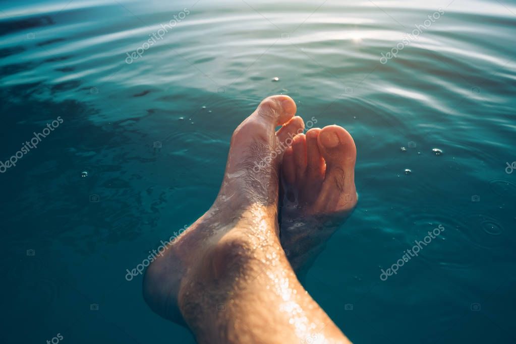 Male feet in outdoor swimming pool — Stock Photo © stevanovicigor