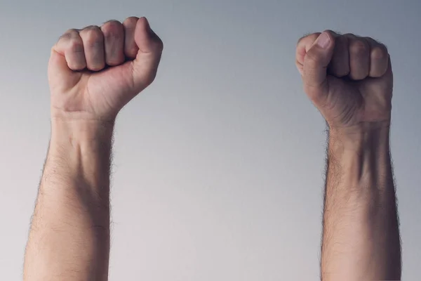 Clenched fists and arms raised in victorious manner — Stock Photo, Image