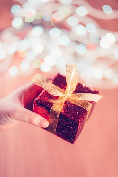 Female hand with Christmas gift box — Stock Photo, Image