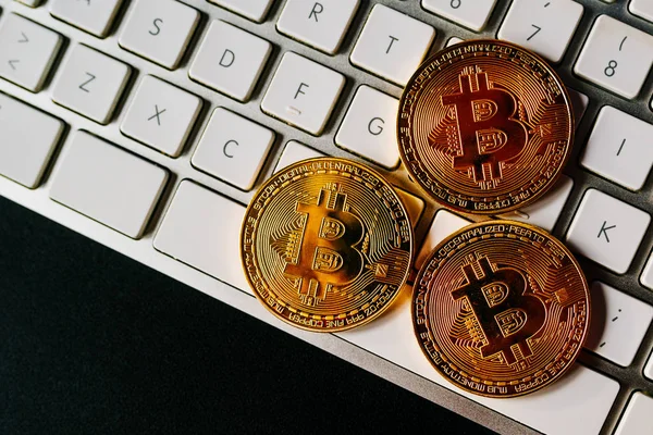 Bitcoins on computer keyboard — Stock Photo, Image