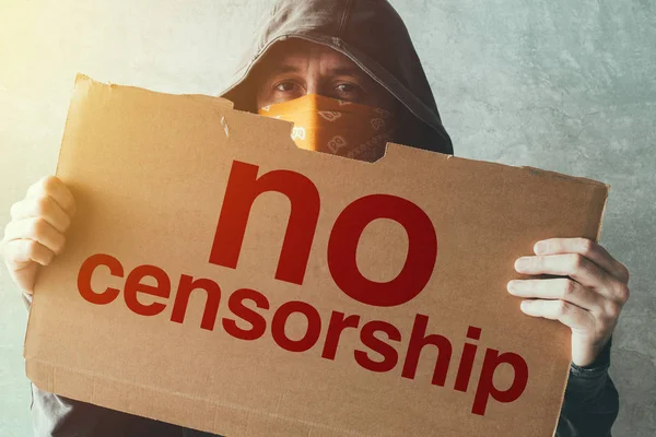 Hooded activist protestor holding No Censorship protest sign — Stock Photo, Image