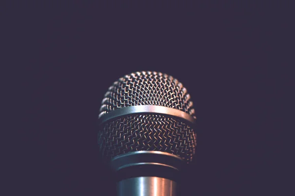 Audio microphone isolated on dark background — Stock Photo, Image