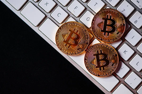 Bitcoins on computer keyboard — Stock Photo, Image