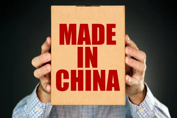 Man holding cardboard box with Made in China — Stock Photo, Image