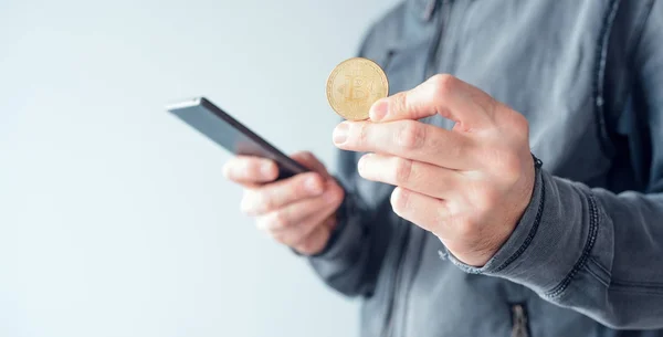 Man with bitcoin and mobile phone — Stock Photo, Image