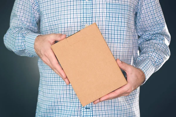 Man holding cardboard box package for mock up design — Stock Photo, Image