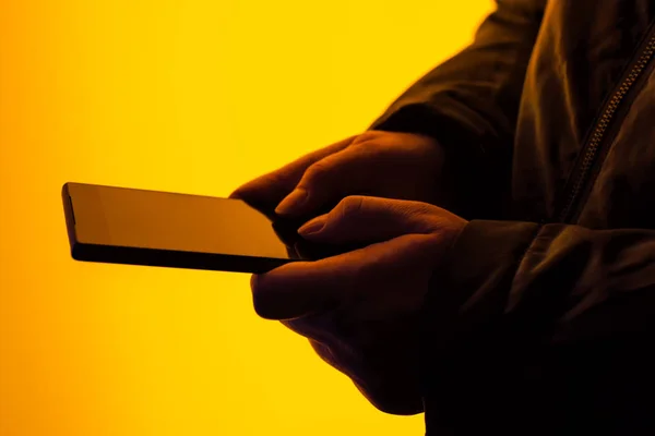 Woman using smartphone on street at night — Stock Photo, Image