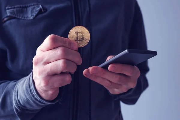 Homem com bitcoin e telefone celular — Fotografia de Stock