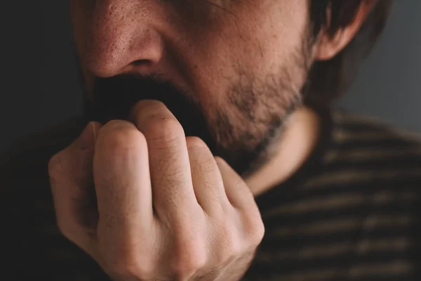 Nervous man bites fingernails — Stock Photo, Image