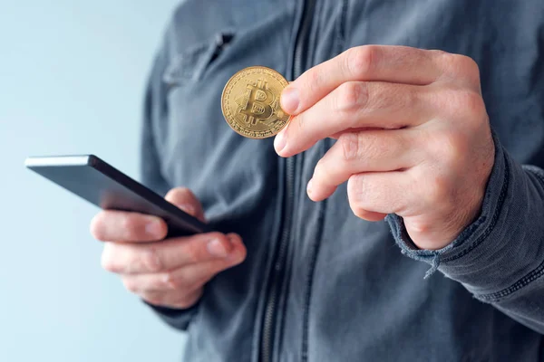 Man with bitcoin and mobile phone — Stock Photo, Image