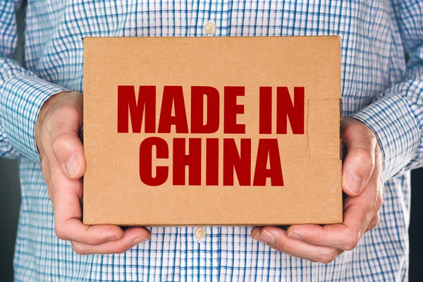 Man holding cardboard box with Made in China — Stock Photo, Image