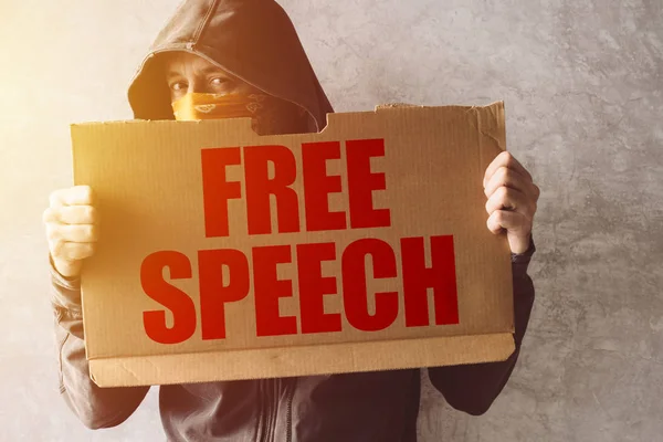 Hooded activist protestor holding Free Speech protest sign — Stock Photo, Image