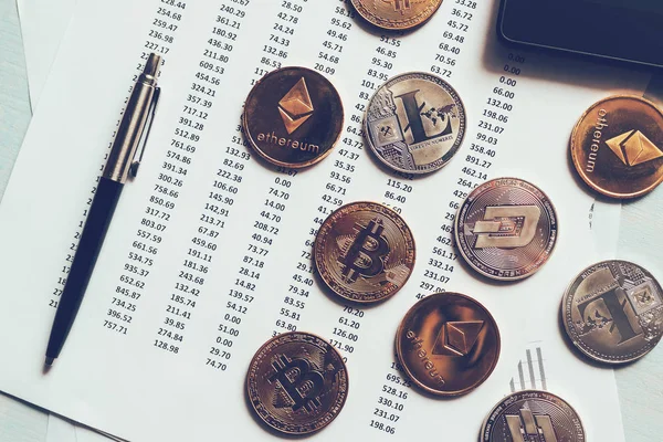 Cryptocurrency coins with exchange rate table — Stock Photo, Image