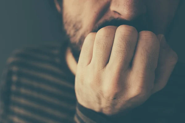 Nervous man bites fingernails — Stock Photo, Image