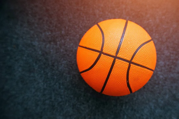 Basketball ball on dark surface — Stock Photo, Image