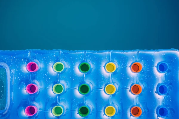 Inflatable mattress floating on swimming pool surface — Stock Photo, Image