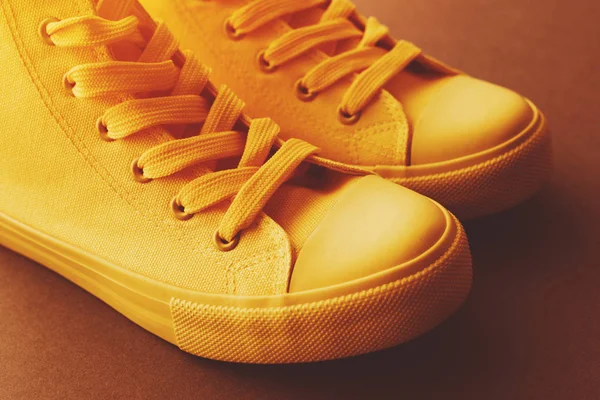 Brand new yellow sneakers on the floor — Stock Photo, Image