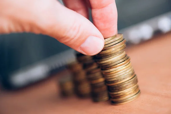 Close up of male hand stacking coins — Stock Photo, Image