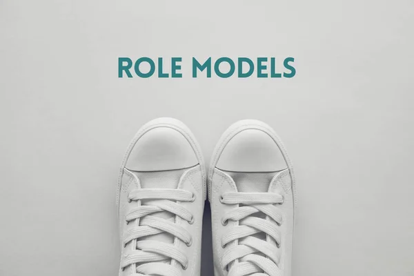 Role model for young people conceptual image with youth lifestyle type sneakers from above