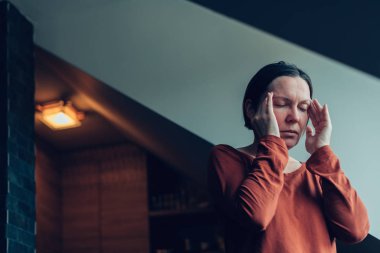 Woman with severe migraine headache clipart