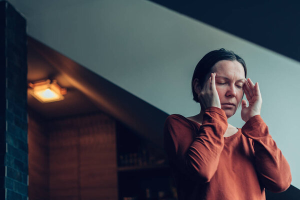 Woman with severe migraine headache