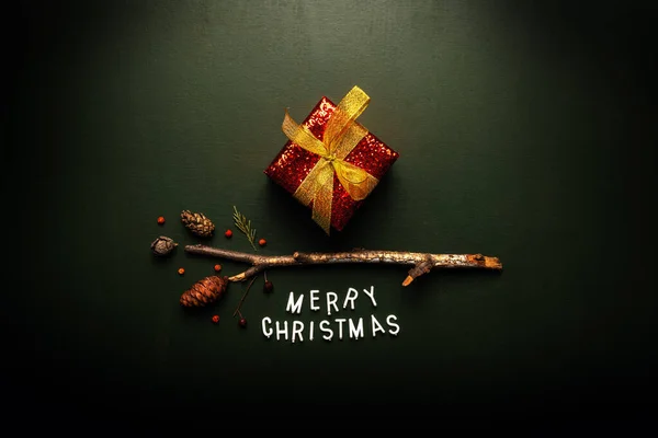 Merry Christmas text flat lay top view on green background — Stock Photo, Image