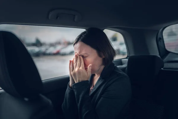 Businesswoman having migraine headache in company car — 스톡 사진