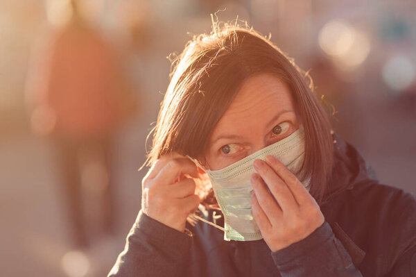 Woman with face protective mask standing on the street