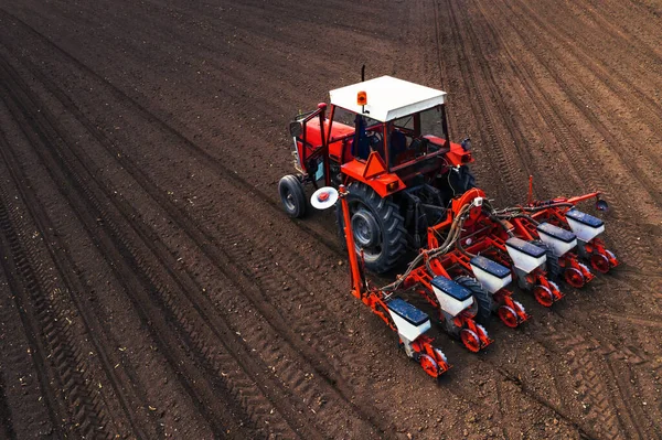 Aerial view of tractor with mounted seeder performing direct see