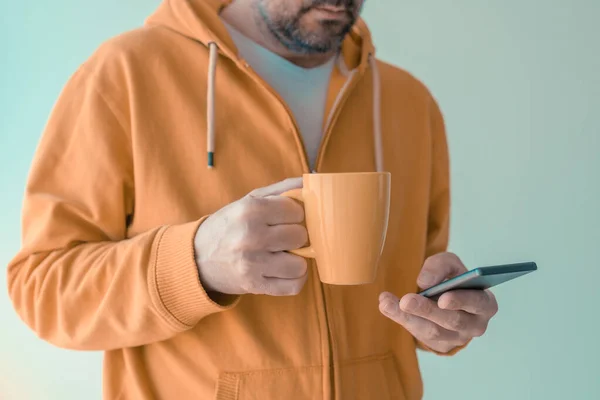 Man Drinking Coffee Using Mobile Phone Morning Adult Male Yellow — Stock Photo, Image