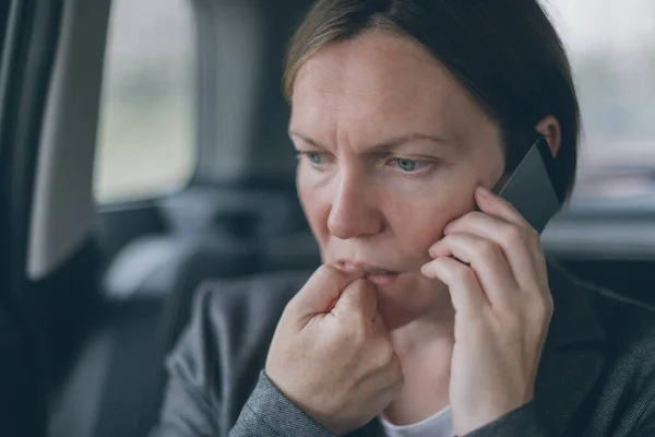 Nervous Businesswoman Biting Nails Talking Mobile Phone Back Seat Car — Stock Photo, Image