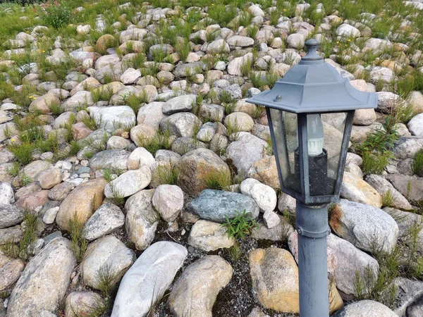 Lanterna de jardim no fundo de aterro de rocha decorativa — Fotografia de Stock