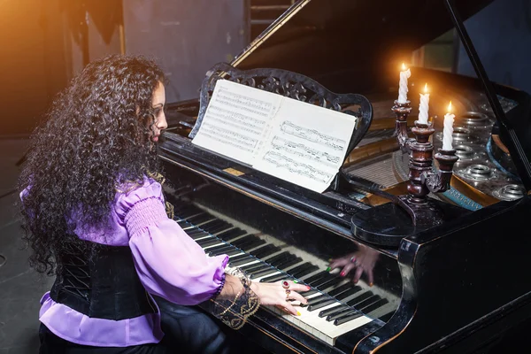 Mystic woman playing piano