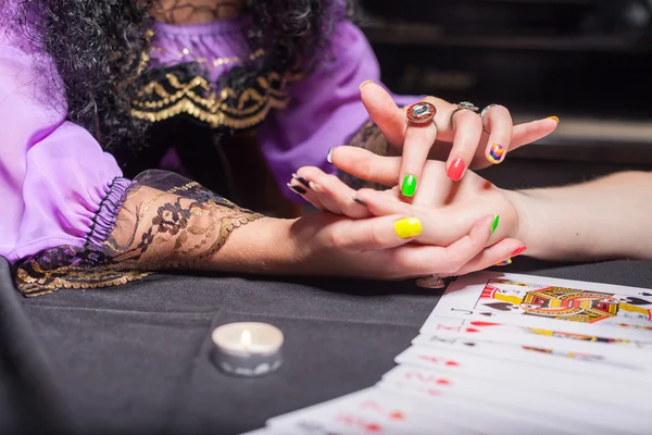 Sorceress reading somebody's hand — Stock Photo, Image