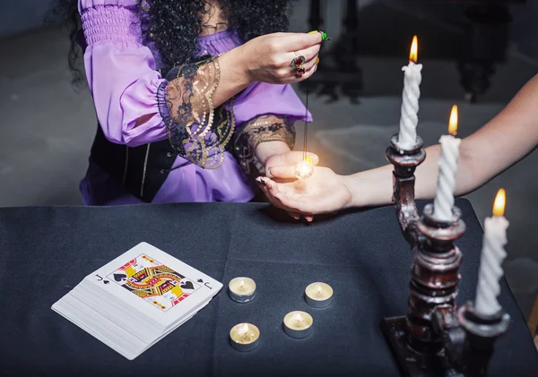 Sorceress reading somebody's hand — Stock Photo, Image