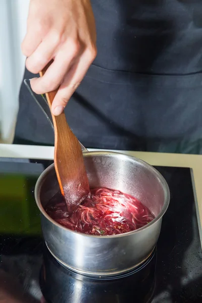 Man 's hands cooking sauce — стоковое фото