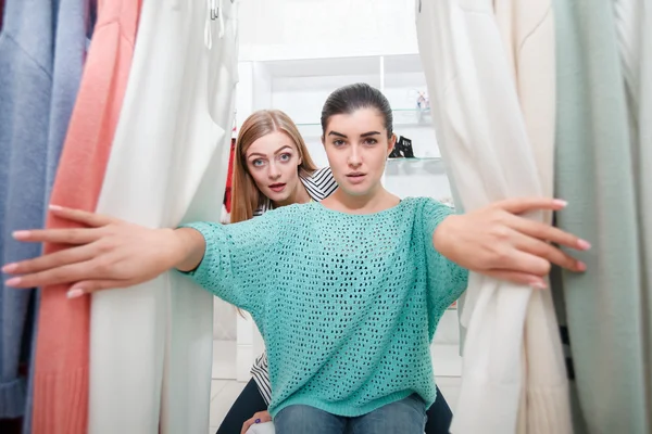 Women near stand with pull-overs — Stock Photo, Image