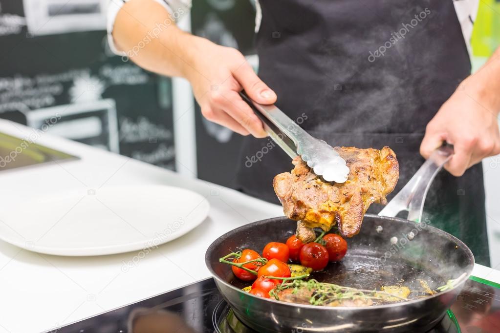  chef cooking meat with vegetables