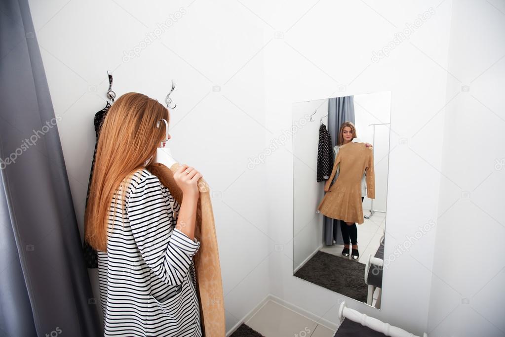 Woman with dress in checkroom