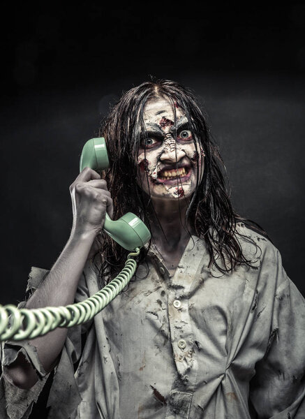 Horror zombie girl calling by phone