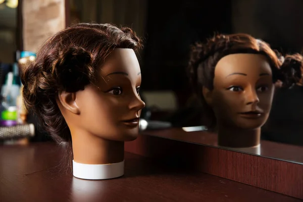 Hairdressing mannequin on wooden table — Stock Photo, Image