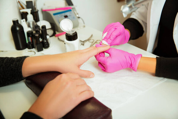 Manicure specialist in gloves making procedure