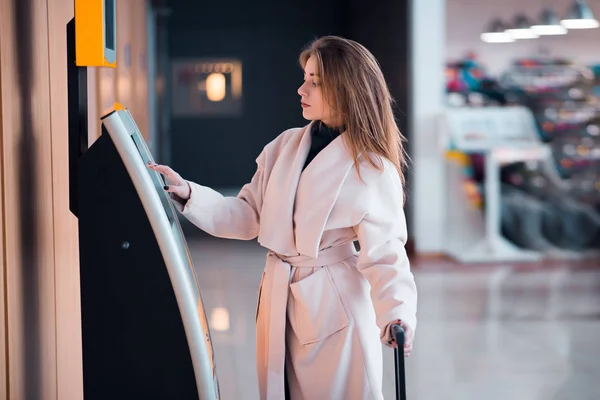 Woman at self service transfer area — Stock Photo, Image