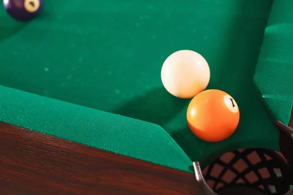 Billiard balls near pocket of billiard table — Stock Photo, Image