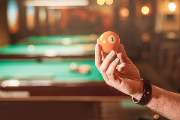 Male hand holding billiard ball — Stock Photo, Image