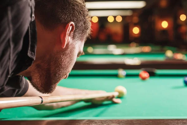 Man trying to hit ball in billiard — Stock Photo, Image